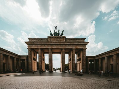 Brandenburg Gate: brown concrete gateway under white clouds