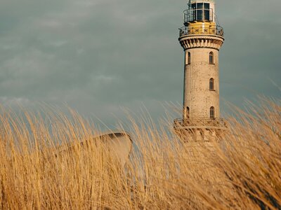 Leuchttrum Warnemünde: Im Frühling am Strand von Warnemünde mit Blick auf den Leuchtturm bei Sonnenuntergang.
