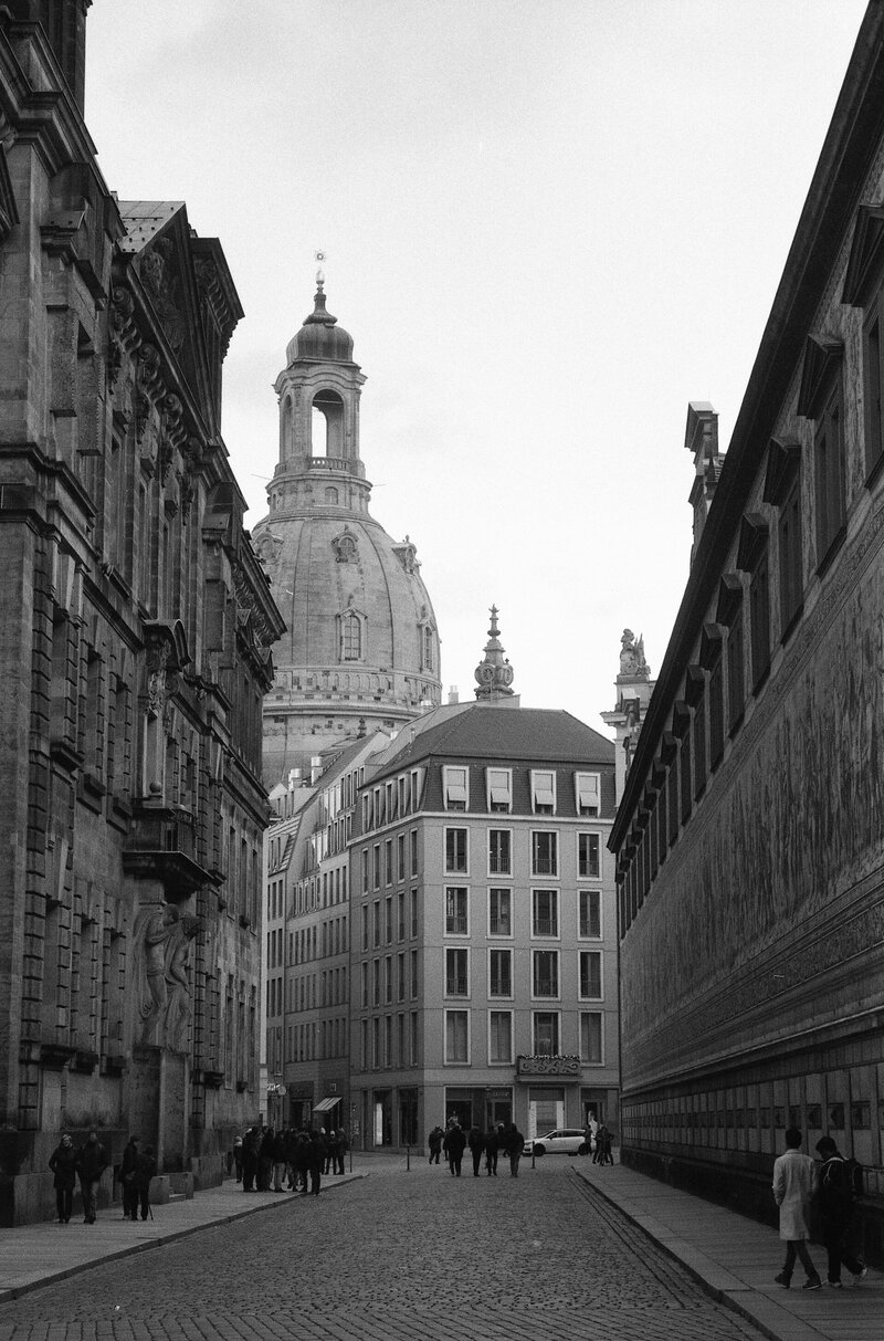a black and white photo of a cobblestone street