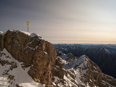 Zugspitze: The golden summit of Zugspitze with mountains in the back