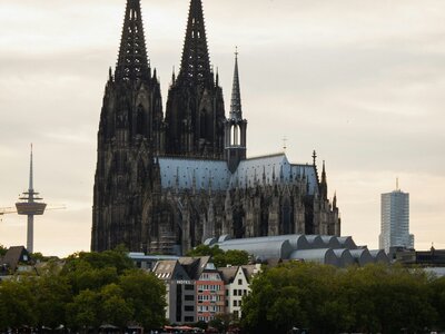 Kölner Dom: a large cathedral towering over a city next to a body of water