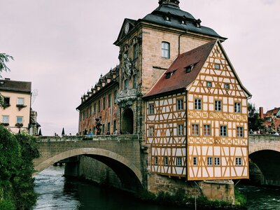 Altes Rathaus Bamberg: brown concrete building near river under white clouds during daytime