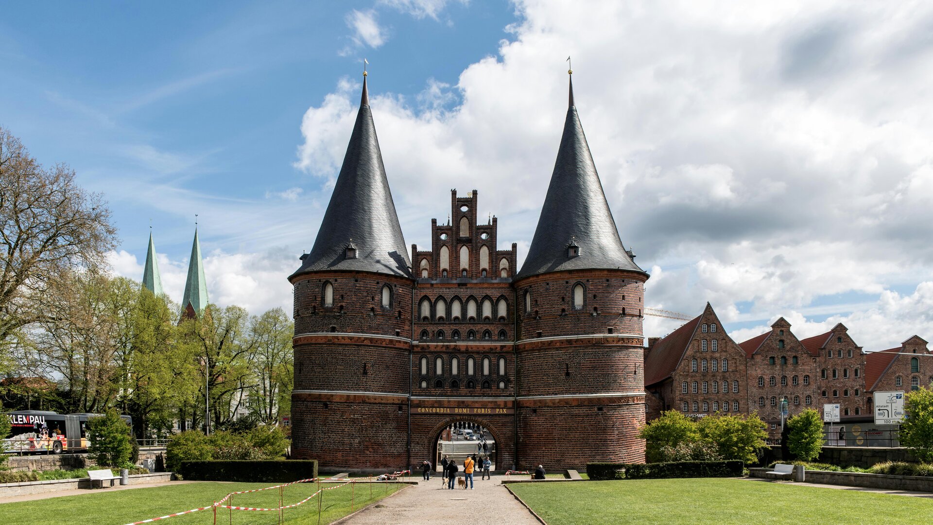 Fotospot Holstentor: a castle like building with a walkway leading to it