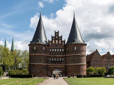 Holstentor: a castle like building with a walkway leading to it