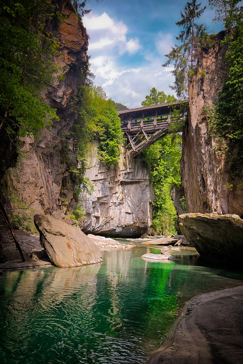 turquoise water under a bridge