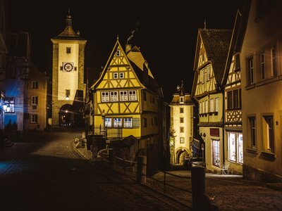 Plönlein: a street at night with a clock tower in the background